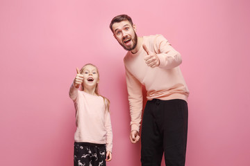 Young father with his baby daughter with thumb up