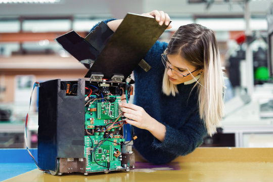 Young Woman Engineer Working On Robotics Project