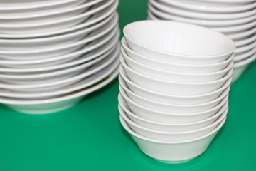 Stacks of white plates on the table. Shopping for the kitchen