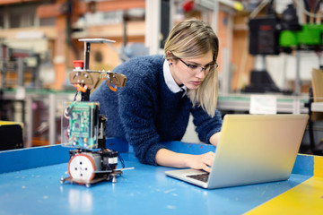 Young woman engineer working on robotics project