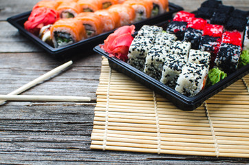 Sushi in a black container on a wooden table colorful and beautiful