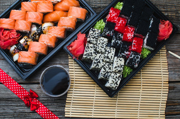 Sushi in a black container on a wooden table colorful and beautiful