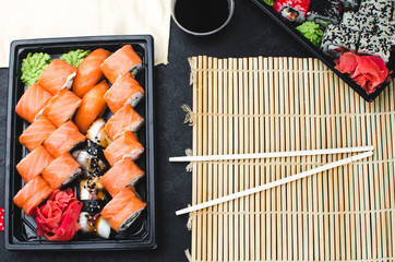 Sushi in a black container on a wooden table colorful and beautiful