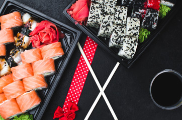 Sushi in a black container on a wooden table colorful and beautiful