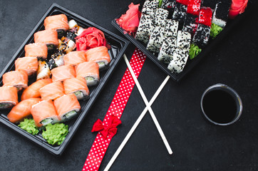 Sushi in a black container on a wooden table colorful and beautiful