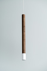 Hanging wooden tube lamp with metal part