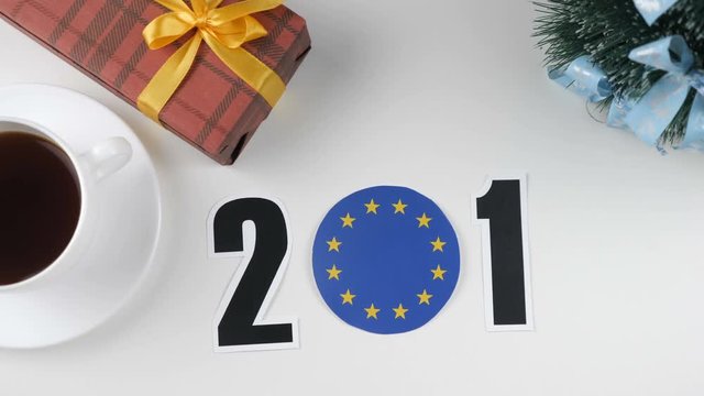Illustration, new year, male hand changes the year from 2017 to 2018, European Union flag, cauntry ball.