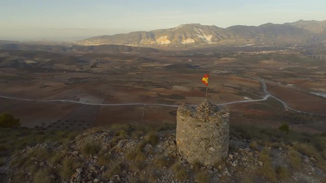 Old Abandoned Watchtower with a Spanish Flag and the Surrounding Landscape