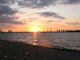 Naklejka premium Great building bridge over the river, building cranes bridge support at sunset