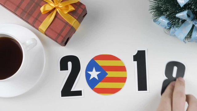 Illustration, new year, male hand changes the year from 2017 to 2018, Catalonia flag, cauntry ball.