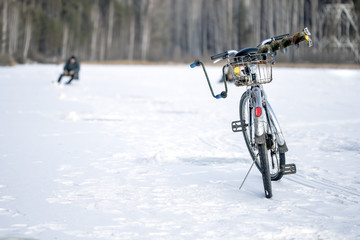 bike on winter fishing, a fisherman in the background out of foсus
