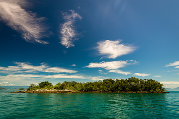 Fototapeta premium Small Island Near Brazilian Coast, With Turquoise Water and Clouds in the Blue Sky