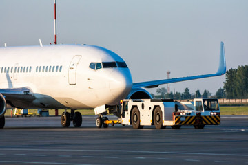 The truck is towing the passenger aircraft