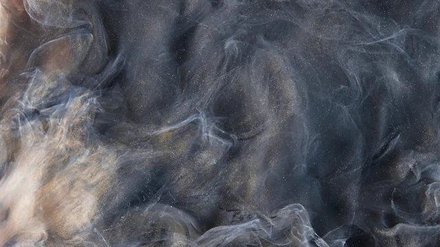 Colorful dark grey and bright yellow paint drops mixing in water. Ink swirling underwater. Cloud of silky ink. Colored abstract smoke explosion animation. Close up view