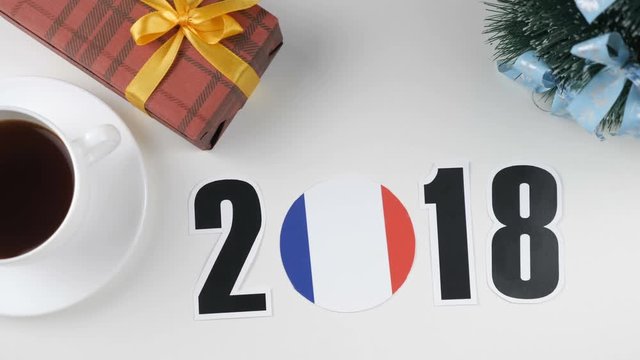 Illustration, new year, male hand put on the table an France flag, cauntry ball, 2018
