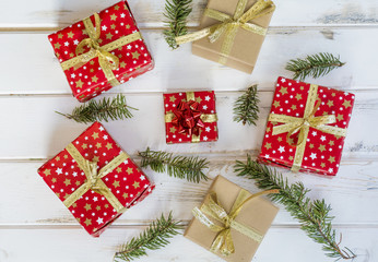 Christmas Present with Golden Bow on White Rustic Wooden Background. Festive Card.Top view