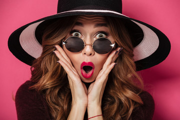 Shocked lady wearing hat and sunglasses