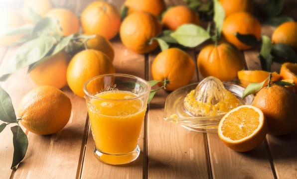 Glass with orange juice on the wooden table