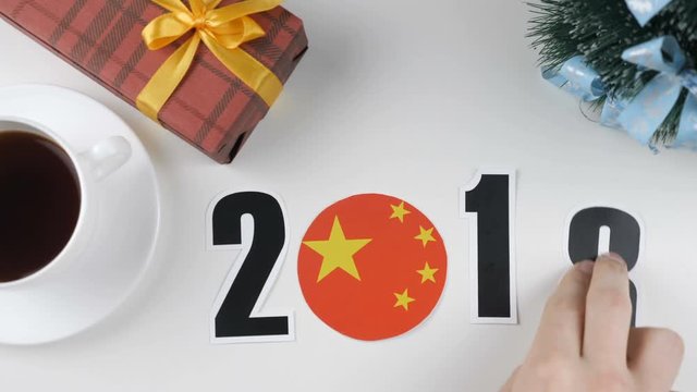 Illustration, new year, male hand changes the year from 2017 to 2018, China flag, cauntry ball.