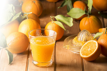 Glass with orange juice on the wooden table