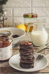 chocolate pancakes in a white plate on the table