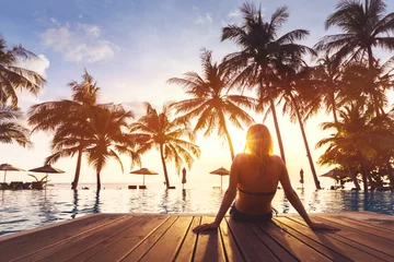 Foto op Aluminium Woman enjoying vacation holidays luxurious beachfront hotel resort swimming pool © NicoElNino