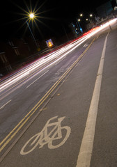 cycle lane at night with lights of cars passing