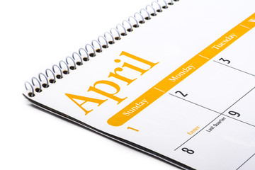 Desk top calendar April close up on white background