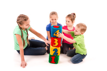 Happy kids holding blocks with numbers over white background
