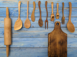 wooden kitchen accessories on a blue wooden table. 