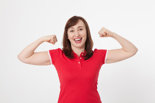Strong woman showing her muscularity and looking at camera isolated on white. Copy space and blank shirt. Mother day