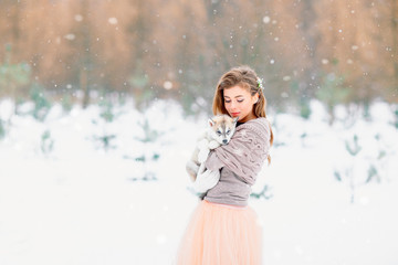 Beautiful bride holding a husky puppy. © Valery