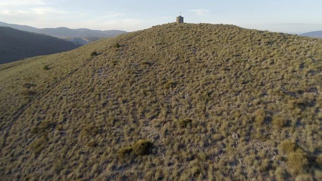 Flight Past an Abandoned Watchtower in Spain with a Flying Flag