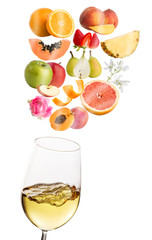 Conceptual fruit aromas floating above white wine glass.