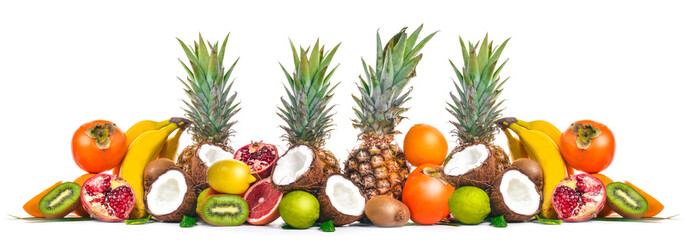 Fresh Tropical Fruits. Pineapple, coconut, kiwi, orange, pomegranate, grapefruit. On a wooden background. Top view. Free space for text.