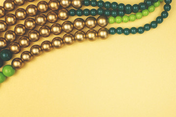 Texture of colored yellow, gold and green beads