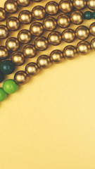 Texture of colored yellow, gold and green beads