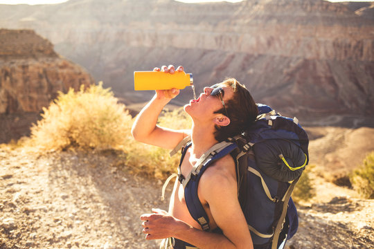 Teenage Backpacker Drinking From Waterbottle