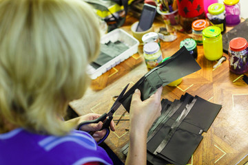 woman cutting a part of a wallet