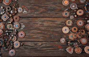 Ethnic ornaments made of hand-made clay on an old wooden table
