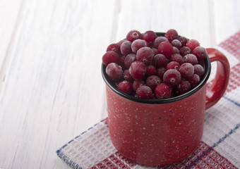 Frozen cranberries in a red cup
