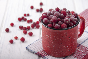 Frozen cranberries in a red cup