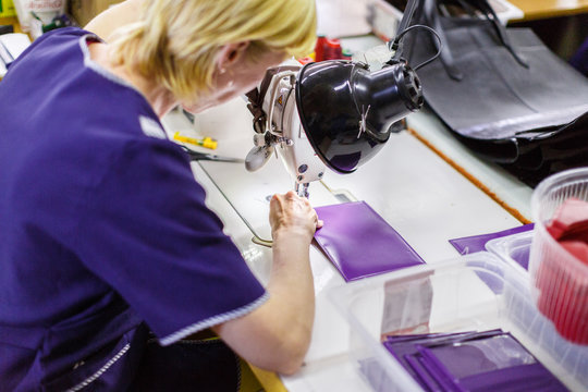 woman stitching a purse