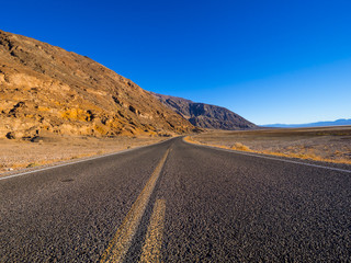 Fototapeta na wymiar Scenery route through Death Valley National Park - lonesome road in the desert
