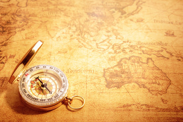 Fototapeta na wymiar Old vintage compass on vintage map