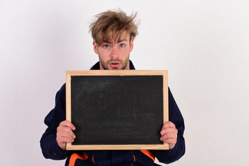 Mechanic or repairer holds blackboard with copy space. © be free