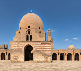 Fototapeta premium Courtyard of Ibn Tulun Mosque, Cairo, Egypt with ablution fountain and minaret in far distance