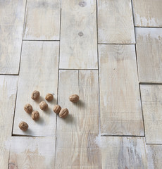 Opened and closed walnuts in a plate on a background of cloth and burlap
