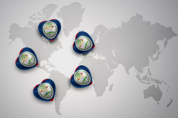 five hearts with national flag of belize on a world map background