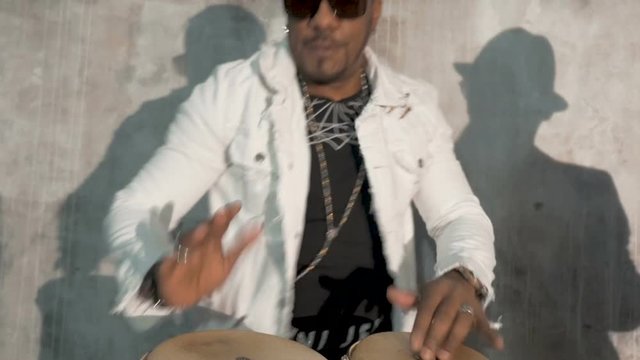African male musician playing drums. Very emotional. Close-up.